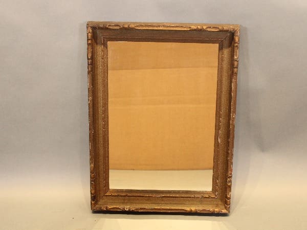 Antique wooden frame with reflective glass.