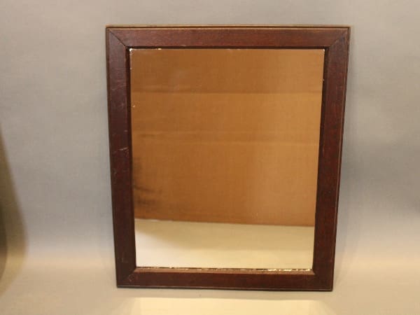 Wooden-framed rectangular mirror on display.