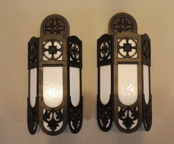 Two decorative wall sconces with ornate design.