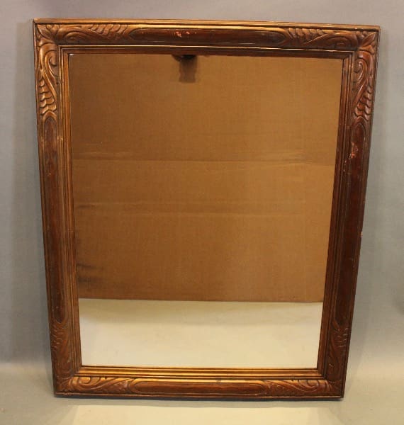 Ornate wooden framed rectangular mirror.