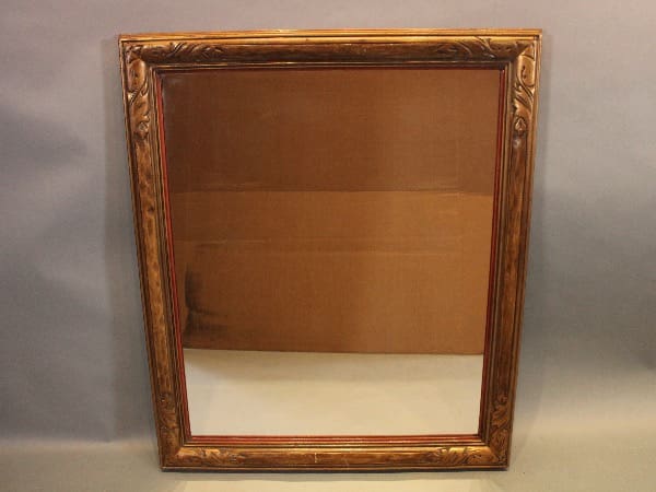 Ornate vintage mirror with wooden frame.