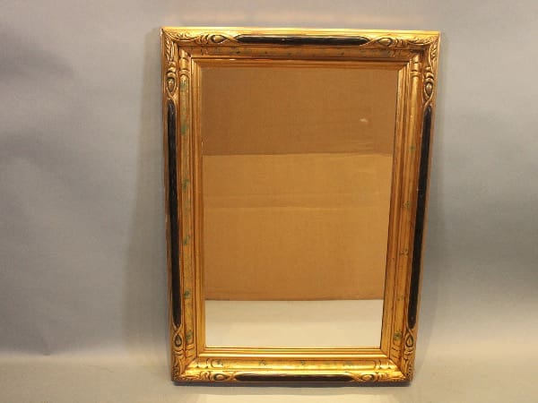 Ornate rectangular gold-framed mirror on display.