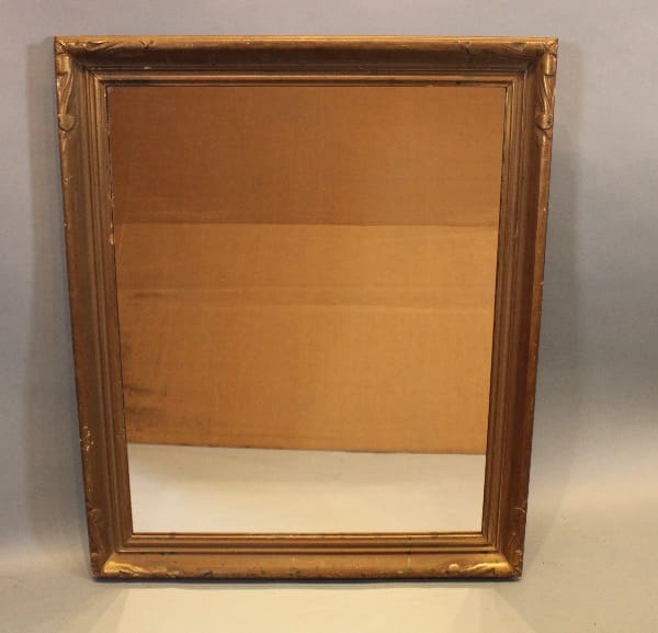 Rectangular vintage mirror with ornate frame.