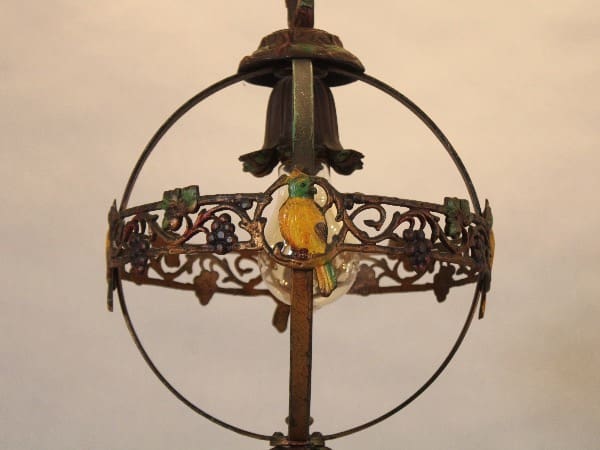 Ornate antique lamp with bird design.