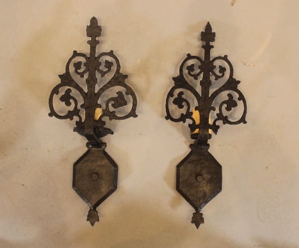 Ornate black wrought iron wall sconces.
