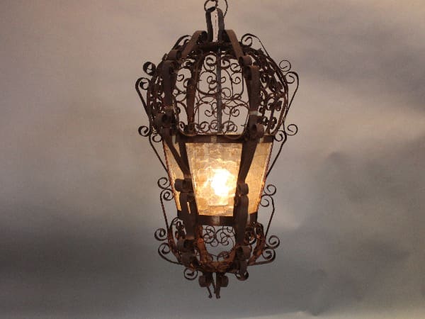Ornate hanging lantern with intricate metalwork design.