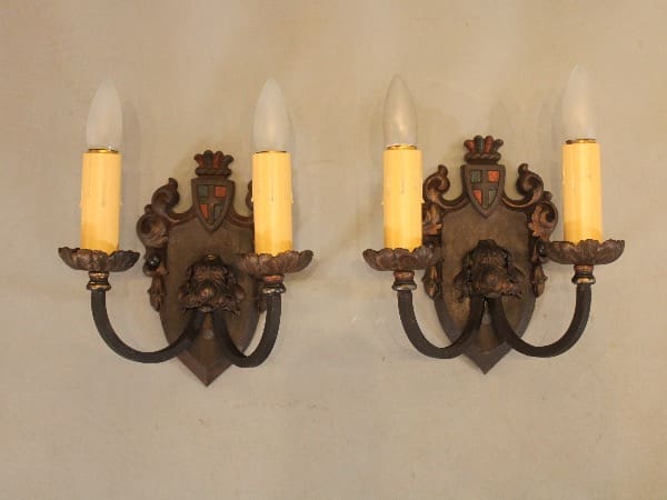 Antique bronze wall sconces with candles.