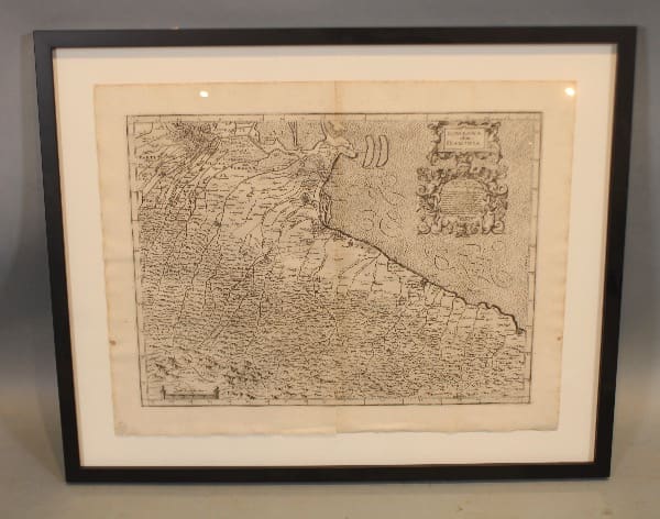 Framed antique map with intricate details.