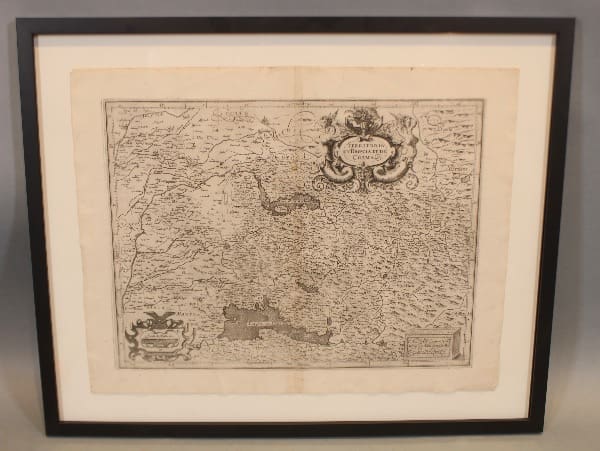 Framed vintage map with decorative elements.