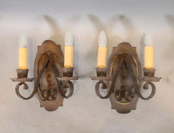 Vintage wrought iron wall sconces with candles.