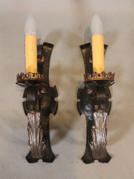 Two ornate candle-shaped wall sconces.
