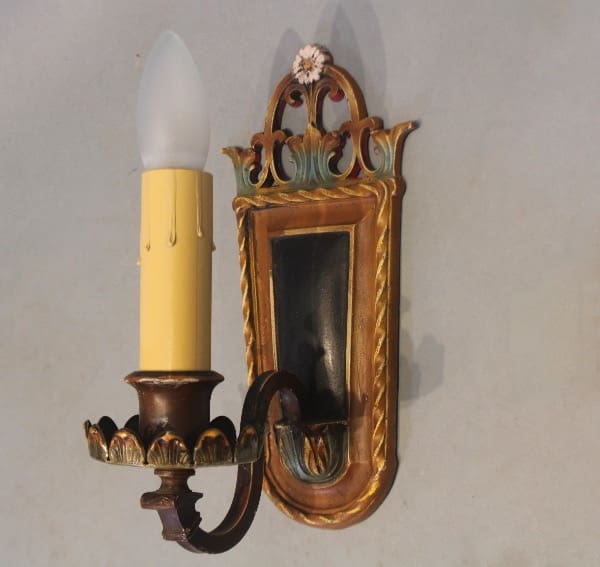 Vintage wall sconce with candle-shaped bulb.