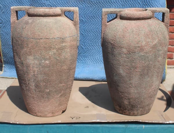 Two large stone urns on display.
