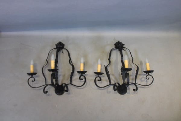 Two ornate black metal wall sconces.