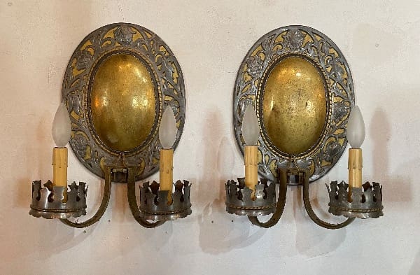 Antique brass wall sconces with candles.