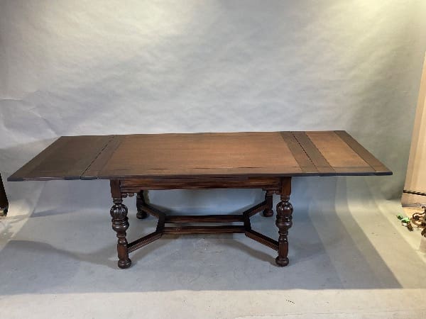 Antique wooden dining table with extensions.