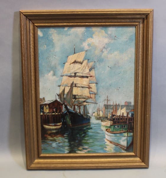 Framed painting of ships in a harbor.