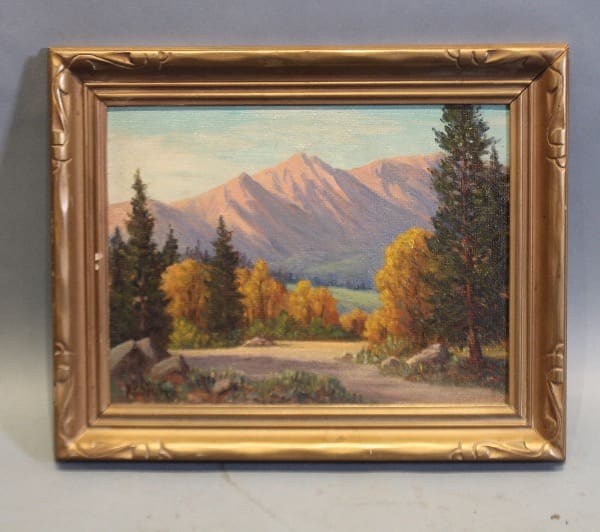 Framed landscape painting with mountains and trees.