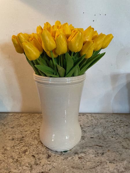 Yellow tulips in a white vase.