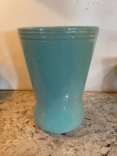 Blue ceramic vase on granite countertop.