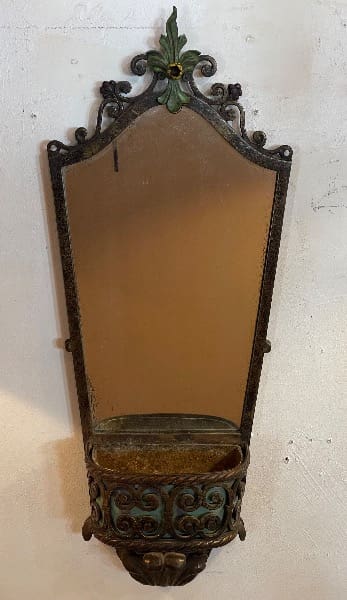 Antique wall mirror with decorative metal frame.