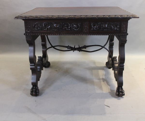 Ornate dark wood table with carved legs.
