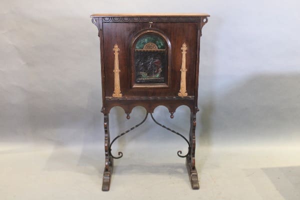 Antique wooden cabinet with ornate metal legs.