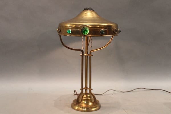 Brass lamp with green decorative accents.