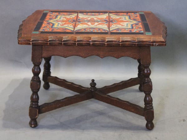 Antique wooden table with colorful tile inlay.