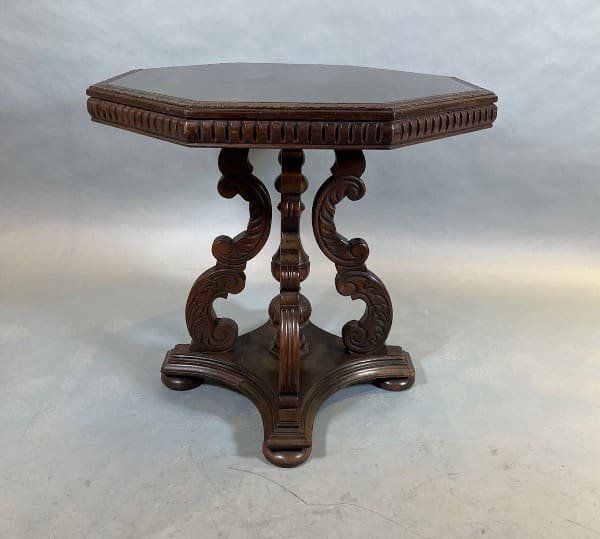 Ornate wooden table with intricate carved legs.