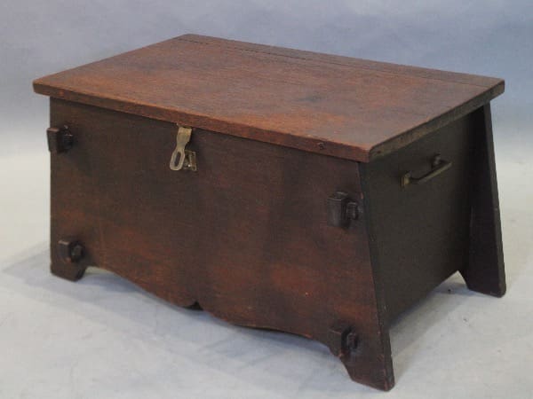 Wooden chest with metal handles and latch.