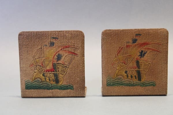 Embossed ship design bookends on display.