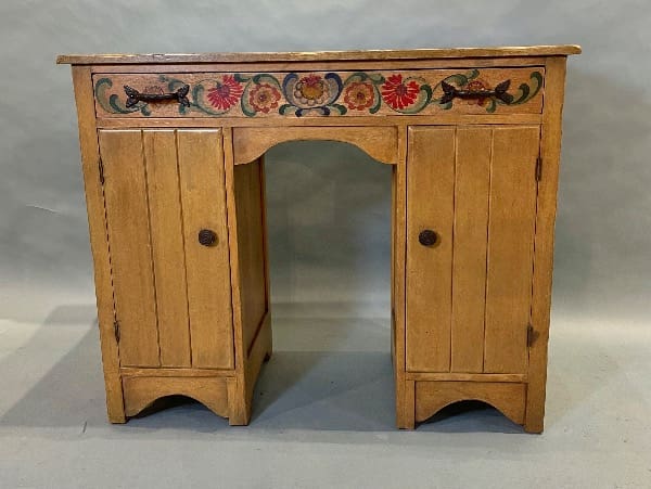 Wooden cabinet with floral painted design.