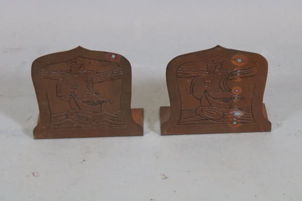 Two decorative wooden bookends with carvings.