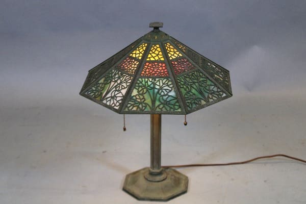 Stained glass table lamp with colorful shade.