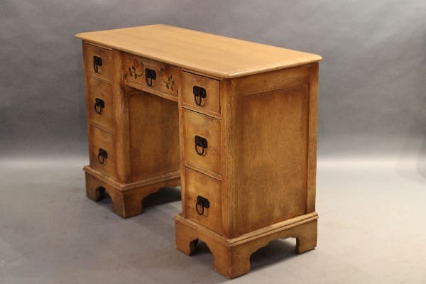 Vintage wooden desk with multiple drawers.