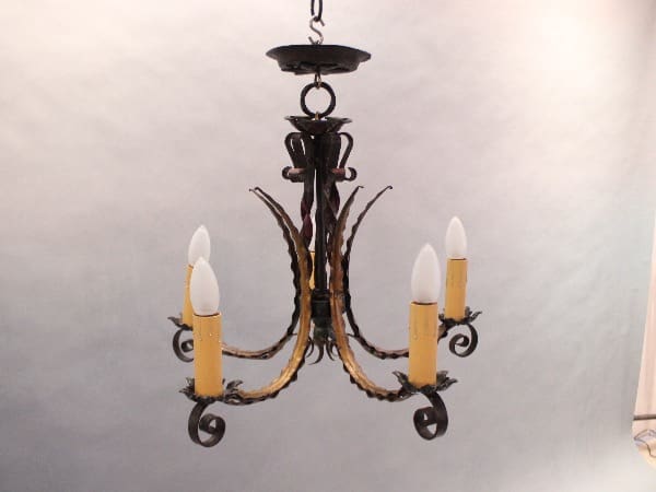 Vintage wrought iron chandelier with candles.