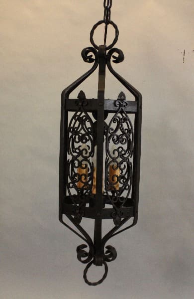 Ornate wrought iron hanging lantern with candles.