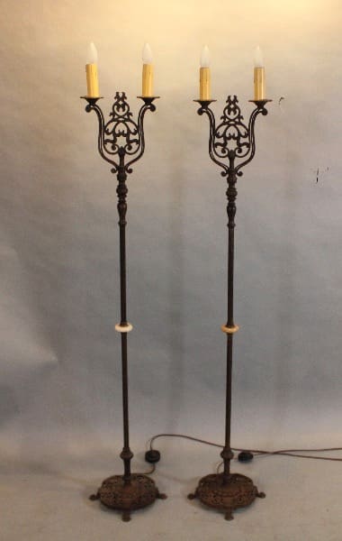 Two ornate vintage floor lamps with bulbs.