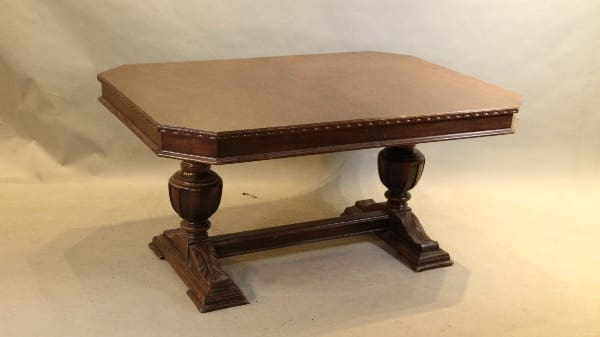 Ornate wooden table with pedestal legs.