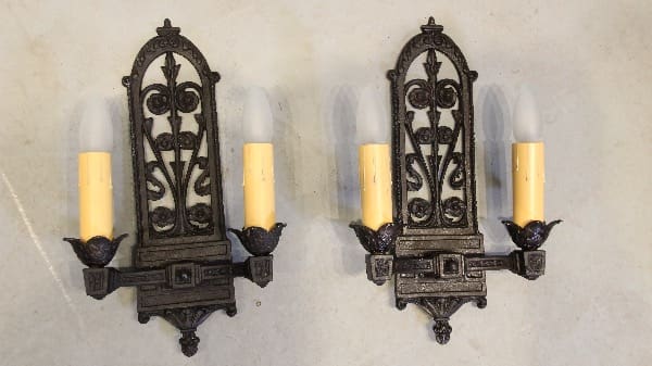 Vintage wrought iron wall sconces with candles.