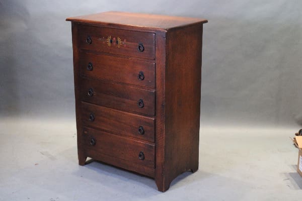 Wooden dresser with five drawers, vintage style.