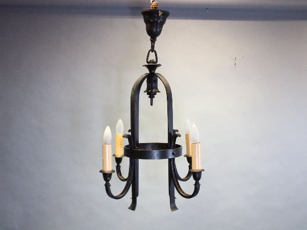 Vintage wrought iron chandelier with candles.