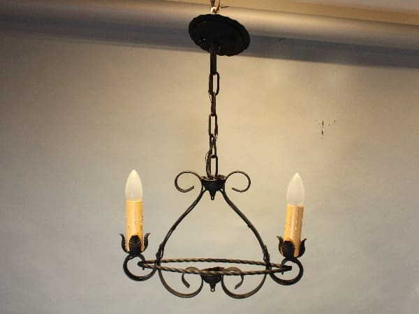Vintage wrought iron chandelier with candles.