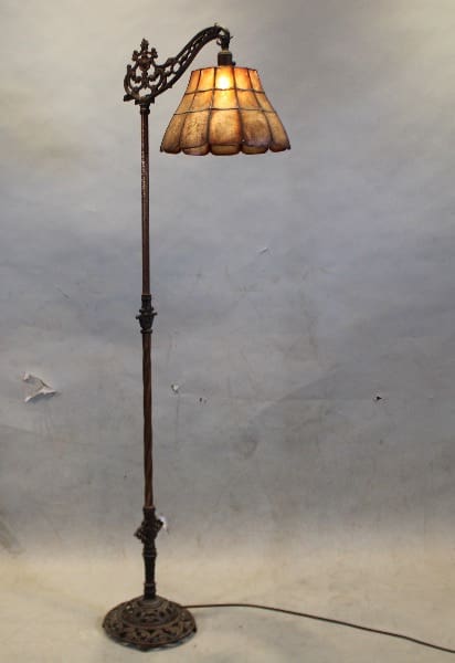 Antique floor lamp with ornate shade.
