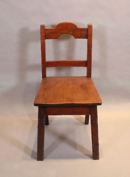 Wooden chair with simple ladder-back design.