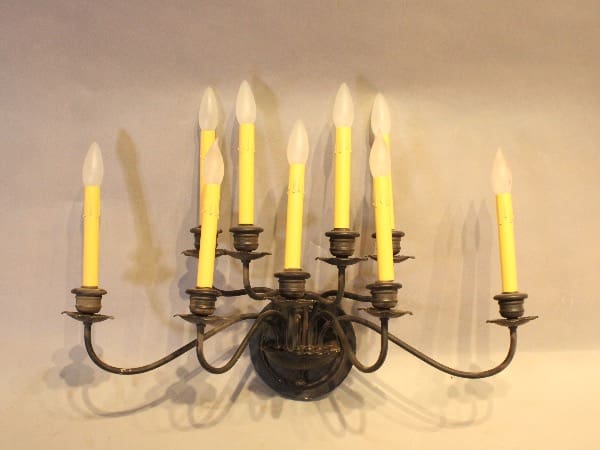 Vintage wall sconce with yellow candle lights.