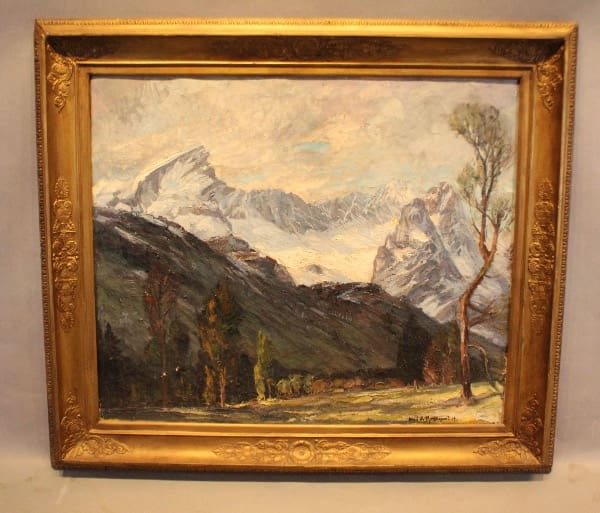 Painting of mountains in an ornate frame.