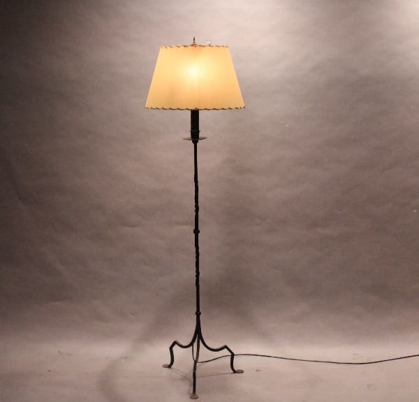 Tall floor lamp with beige lampshade.