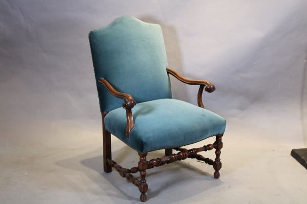 Antique wooden chair with green upholstery.